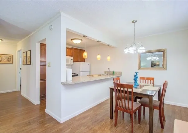 a view of a dining room with furniture and wooden floor