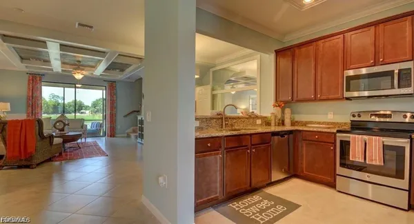 a kitchen with stainless steel appliances granite countertop a stove sink and cabinets