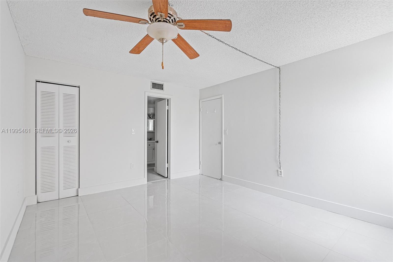 4801 Northwest 7th Street, Unit 40716 Miami, FL 33126 - Photo 11 of 26 an empty room with chandelier fan