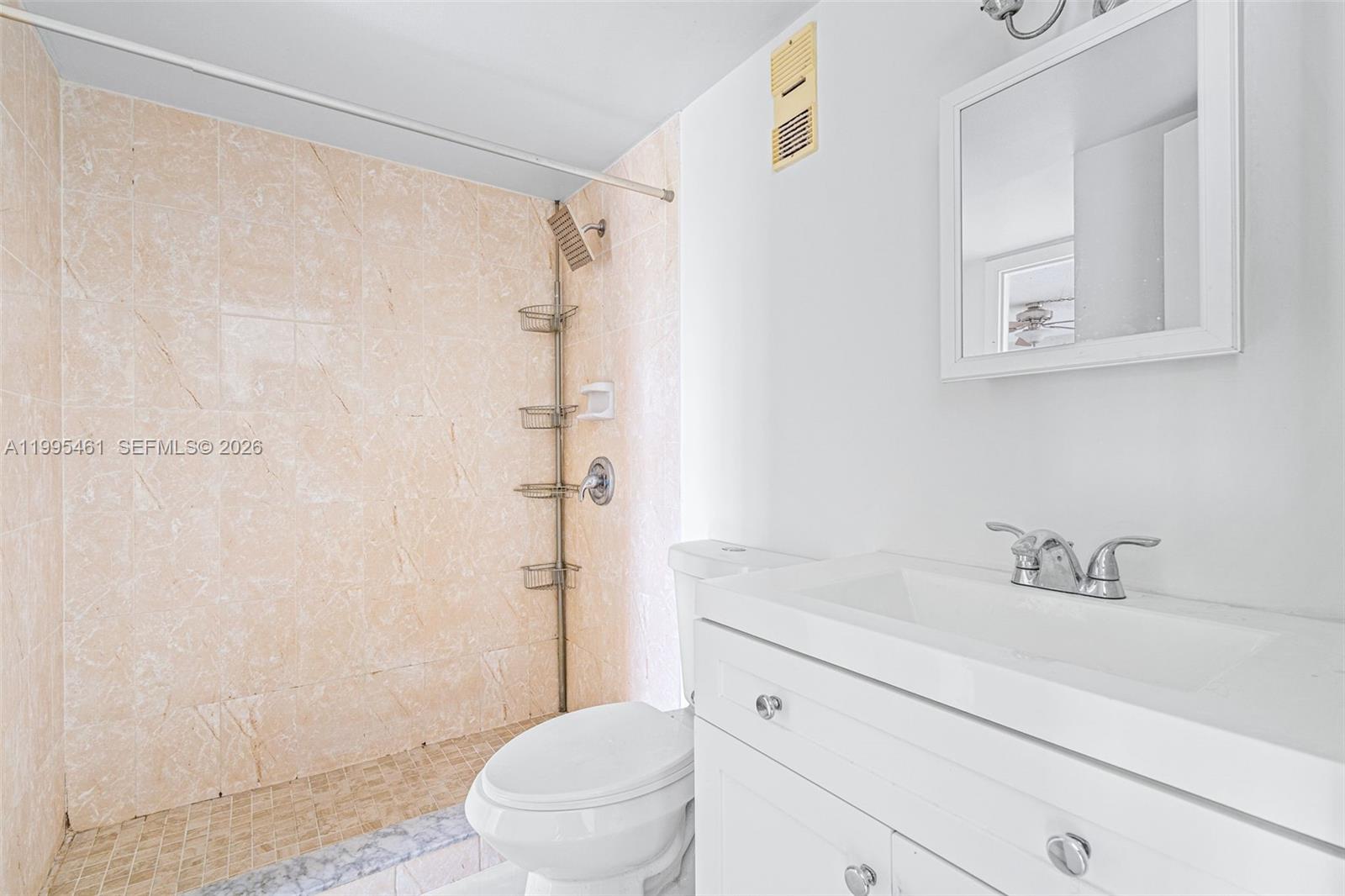 4801 Northwest 7th Street, Unit 40716 Miami, FL 33126 - Photo 13 of 26 a bathroom with a sink a toilet and shower