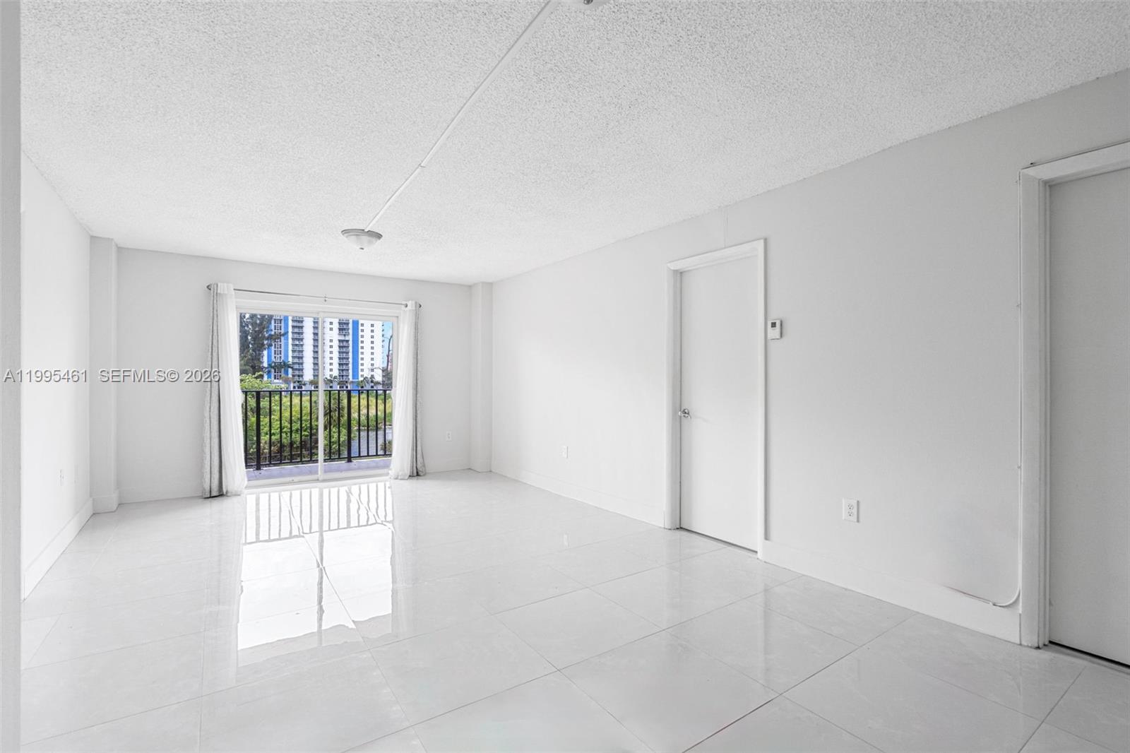 4801 Northwest 7th Street, Unit 40716 Miami, FL 33126 - Photo 2 of 26 an empty room with windows
