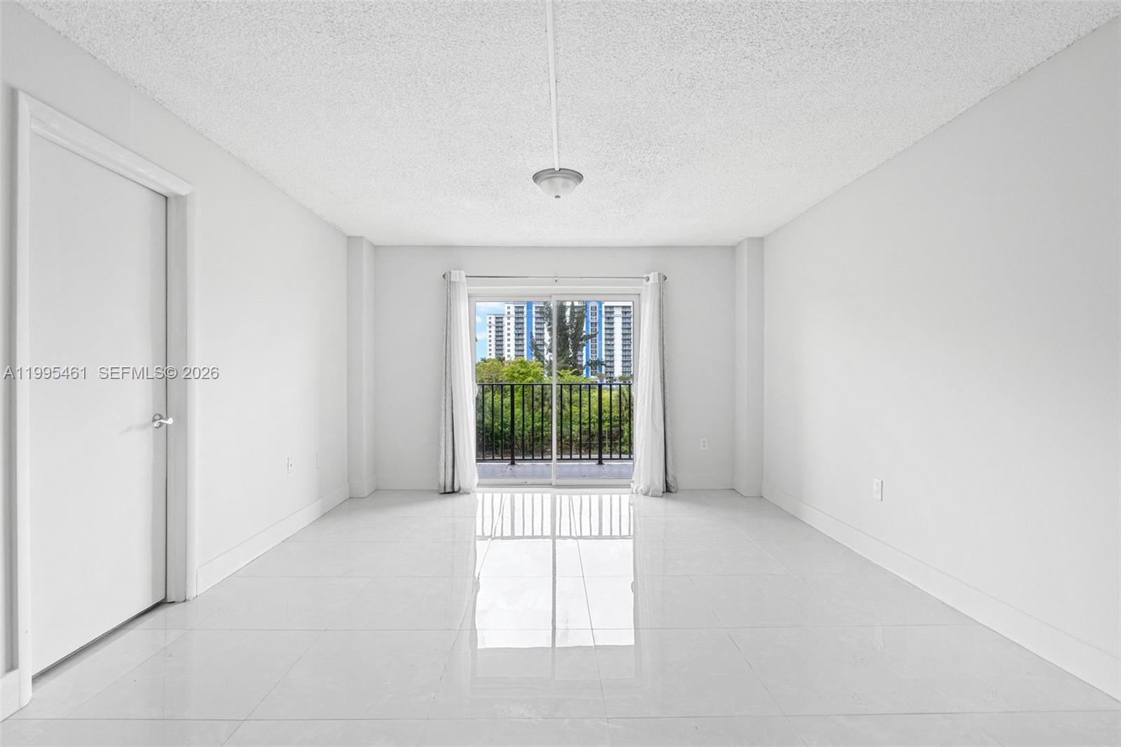 4801 Northwest 7th Street, Unit 40716 Miami, FL 33126 - Photo 3 of 26 a view of an empty room with a window