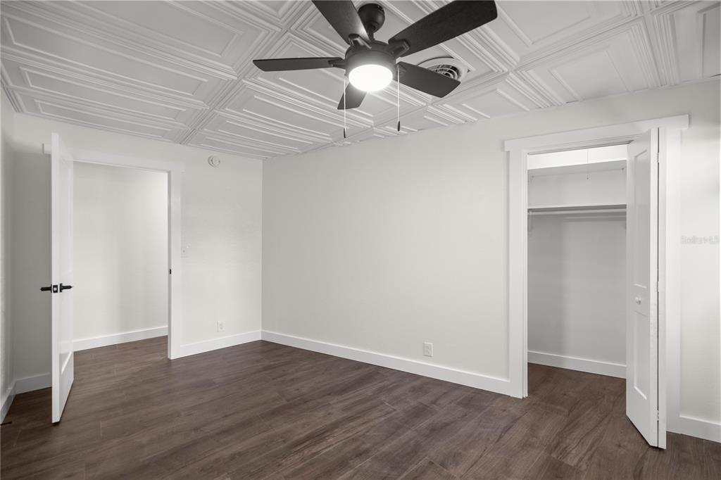 6391 Southeast 186 Terrace Morriston, FL 32668 - Photo 15 of 53 an empty room with wooden floor ceiling fan and windows