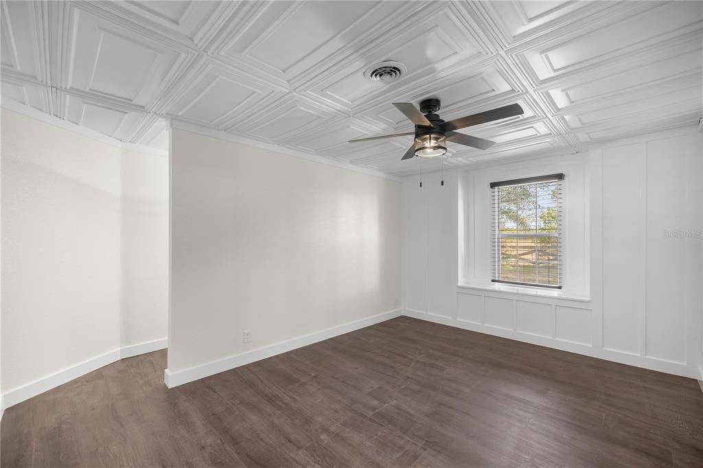 6391 Southeast 186 Terrace Morriston, FL 32668 - Photo 17 of 53 an empty room with wooden floor and windows