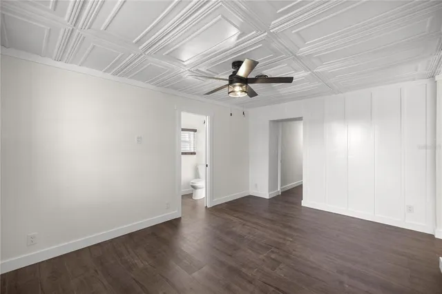a bathroom with a granite countertop sink a mirror and shower