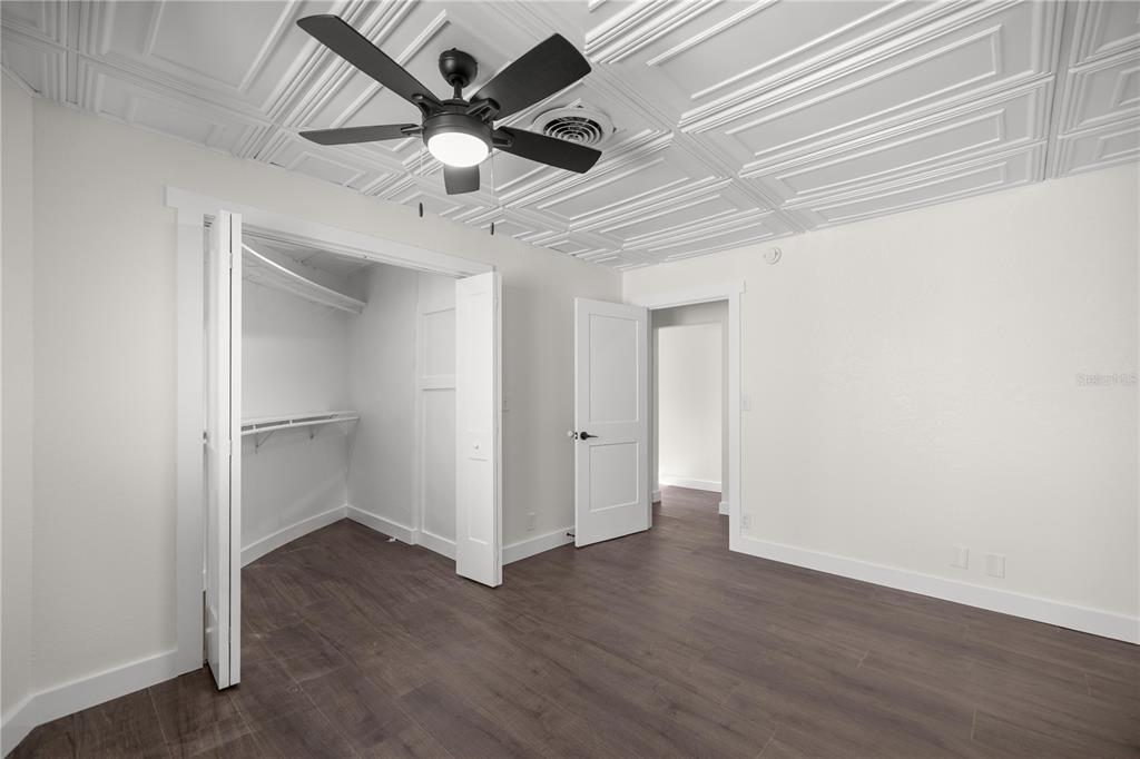 6391 Southeast 186 Terrace Morriston, FL 32668 - Photo 23 of 53 an empty room with wooden floor ceiling fan and windows