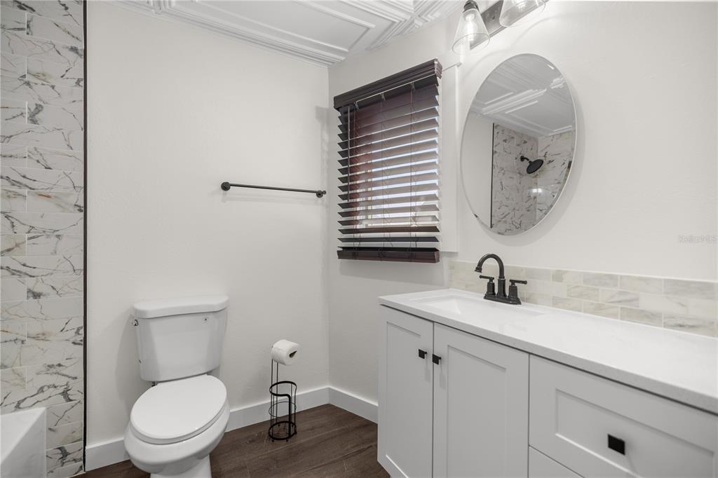 6391 Southeast 186 Terrace Morriston, FL 32668 - Photo 25 of 53 a bathroom with a toilet a sink and mirror