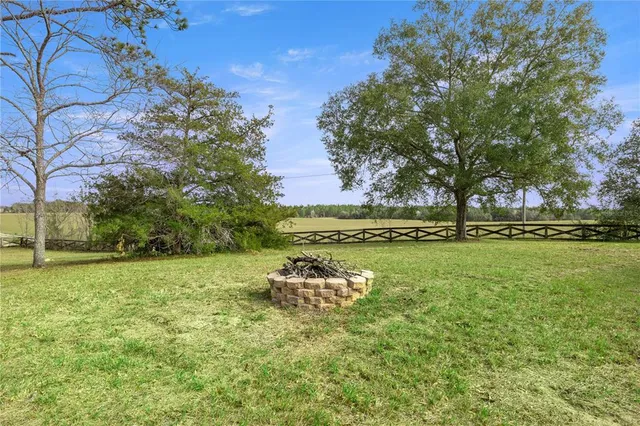 a backyard of a house with table and chairs