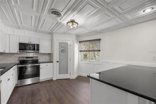 a kitchen with stainless steel appliances a stove a refrigerator and a microwave