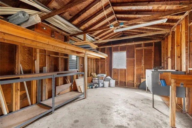 a view of a swimming pool with a yard and trees in the background