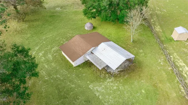 an aerial view of a houses with outdoor space and lake view