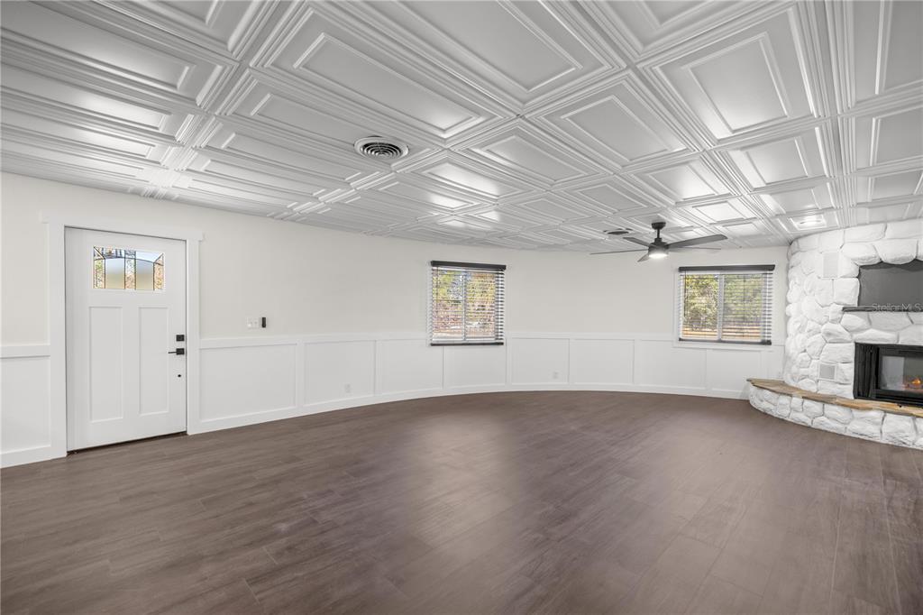 6391 Southeast 186 Terrace Morriston, FL 32668 - Photo 8 of 53 an empty room with wooden floor and windows