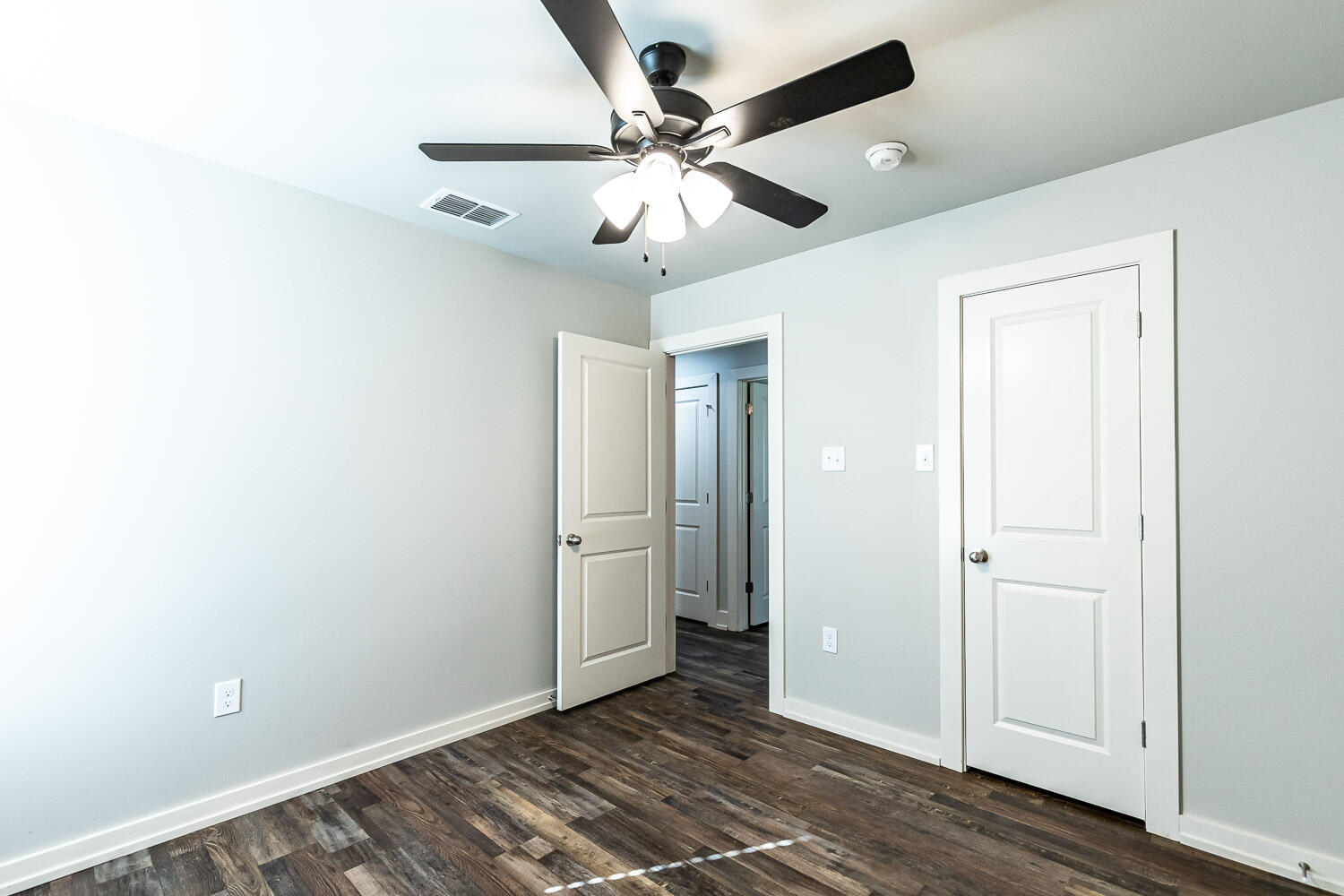 5508 122nd Street Lubbock, TX 79424 - Photo 13 of 20 a view of an empty room with wooden floor
