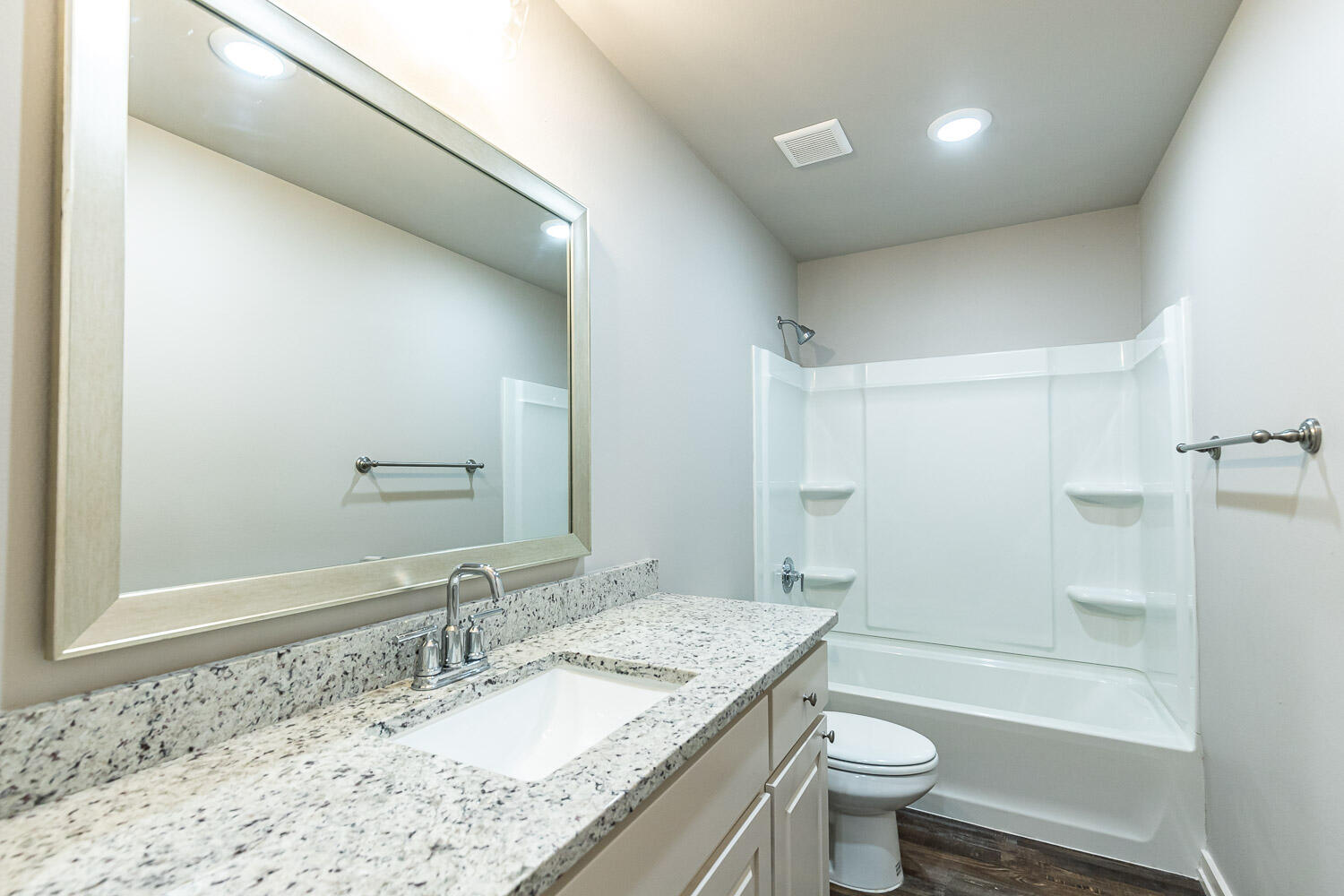 5508 122nd Street Lubbock, TX 79424 - Photo 15 of 20 a bathroom with a granite countertop sink a toilet and shower