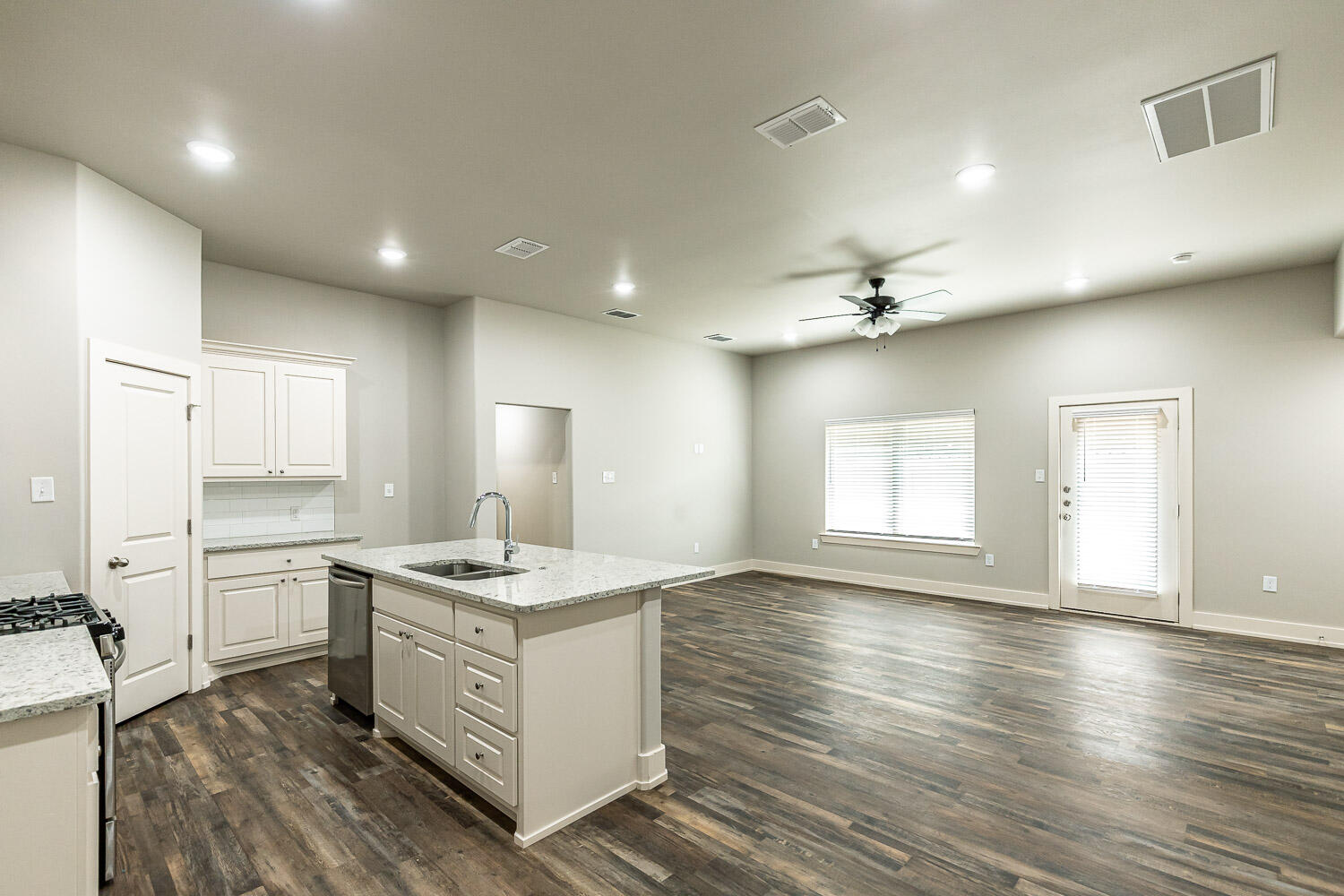 5508 122nd Street Lubbock, TX 79424 - Photo 3 of 20 a kitchen with stainless steel appliances granite countertop a sink stove and wooden floor