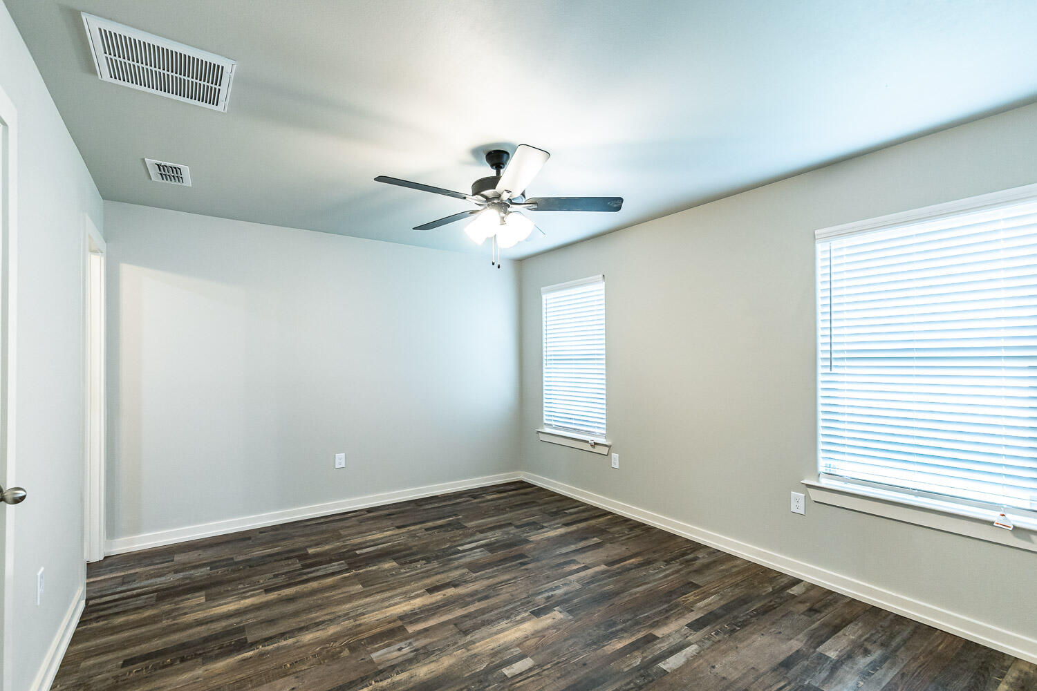 5508 122nd Street Lubbock, TX 79424 - Photo 9 of 20 an empty room with wooden floor and windows