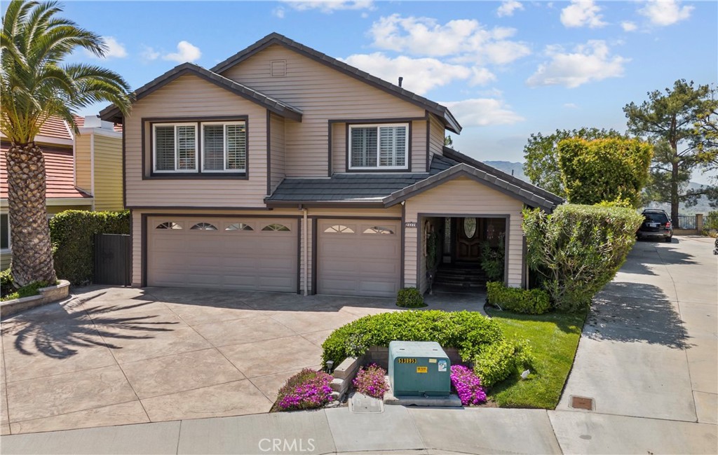 a front view of a house with a garden and plants