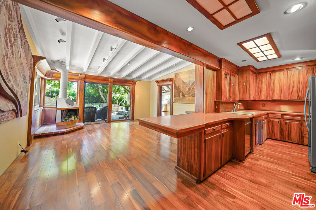 455 El Bosque Laguna Beach, CA 92651 - Photo 12 of 57 a large kitchen with stainless steel appliances wooden floors and large window