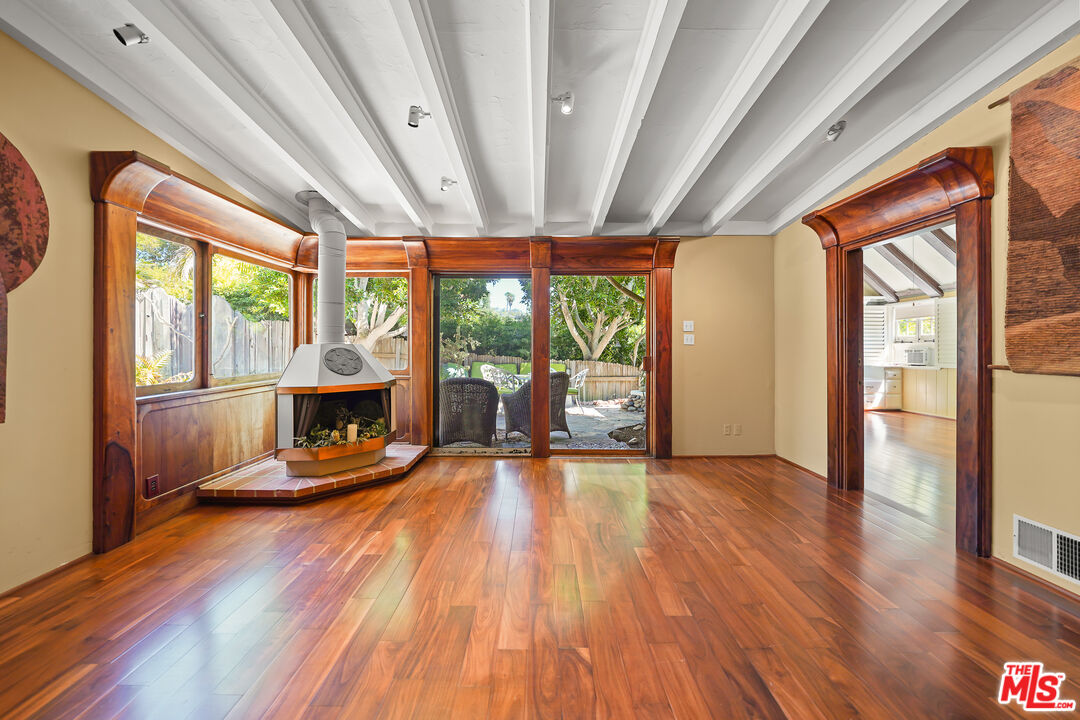 455 El Bosque Laguna Beach, CA 92651 - Photo 14 of 57 a view of empty room with wooden floor and fireplace