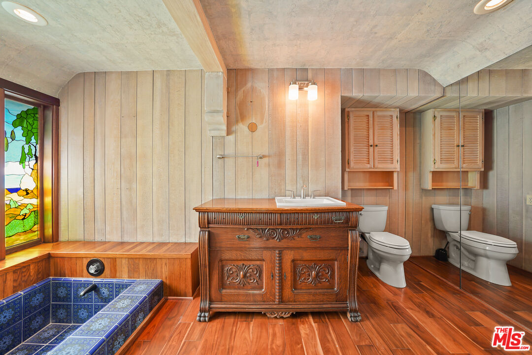 455 El Bosque Laguna Beach, CA 92651 - Photo 20 of 57 a bathroom with a tub toilet sink and mirror
