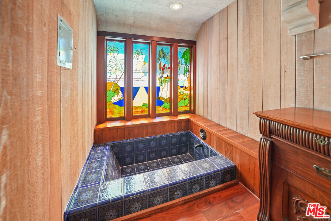 455 El Bosque Laguna Beach, CA 92651 - Photo 22 of 57 a bathroom with bathtub and window