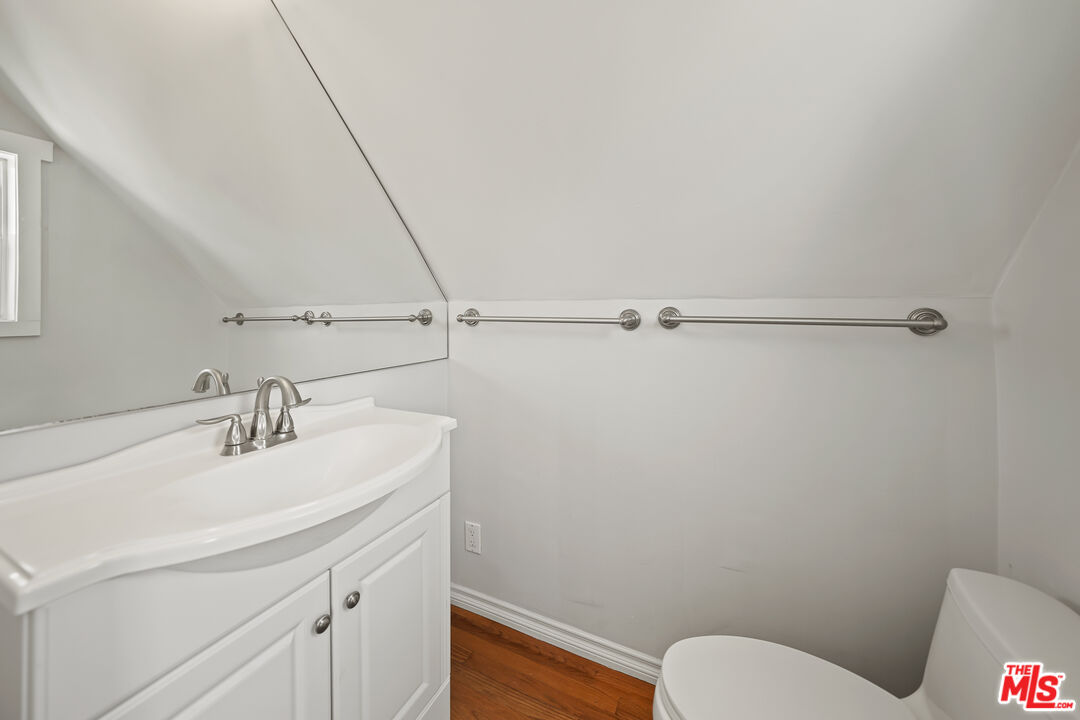 455 El Bosque Laguna Beach, CA 92651 - Photo 34 of 57 a bathroom with a sink mirror vanity and toilet