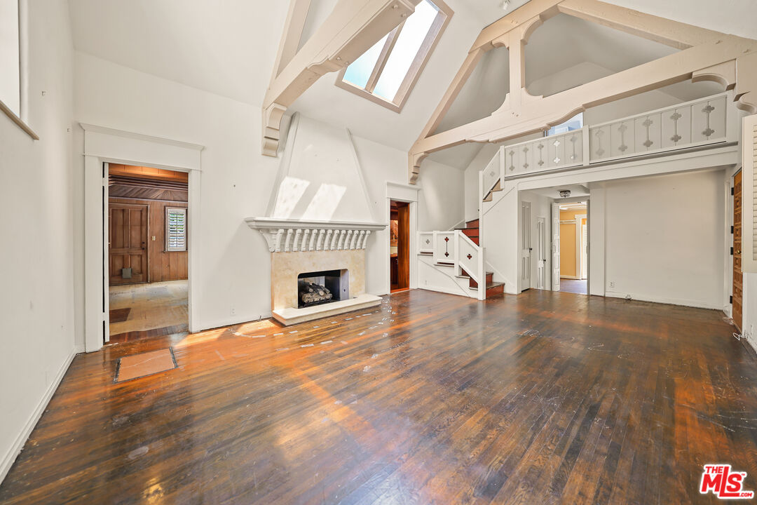 455 El Bosque Laguna Beach, CA 92651 - Photo 6 of 57 a view of a livingroom with wooden floor and a fireplace
