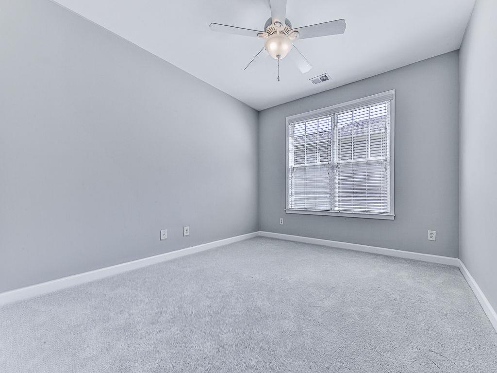 626 Laurel Crossing Canton, GA 30114 - Photo 41 of 77 en empty room with windows and ceiling fan
