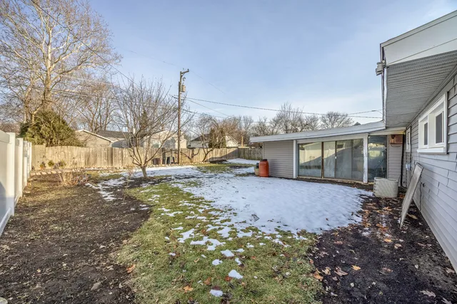 a view of a house with a yard covered in snow