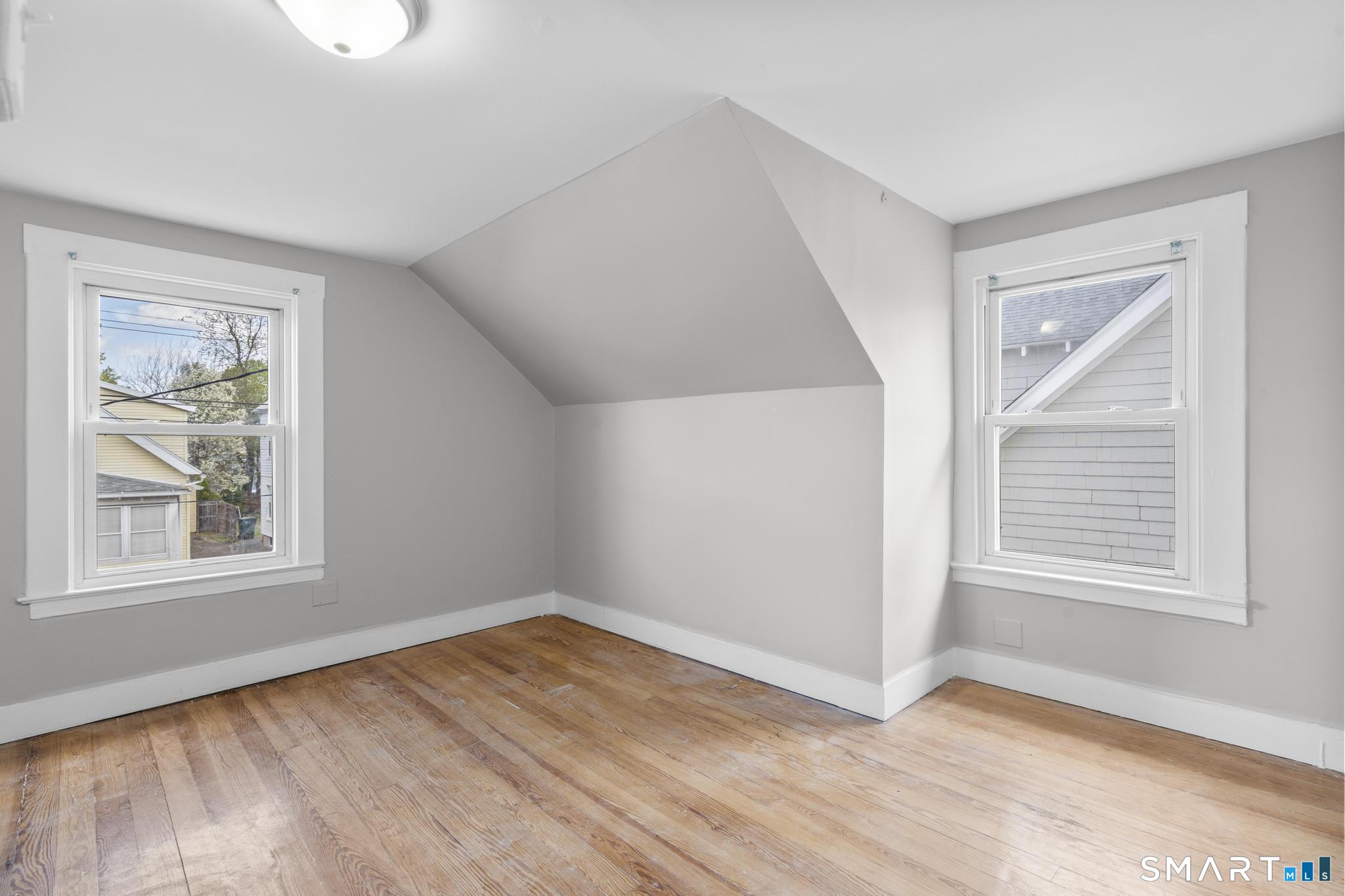 68 Whiting Street Hamden, CT 06514 - Photo 14 of 25 an empty room with wooden floor and windows