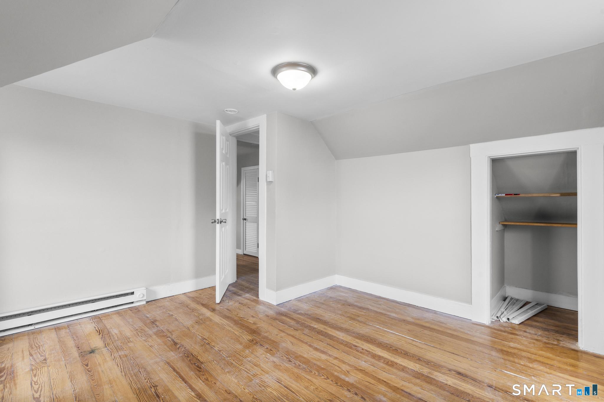 68 Whiting Street Hamden, CT 06514 - Photo 15 of 25 a view of empty room with wooden floor