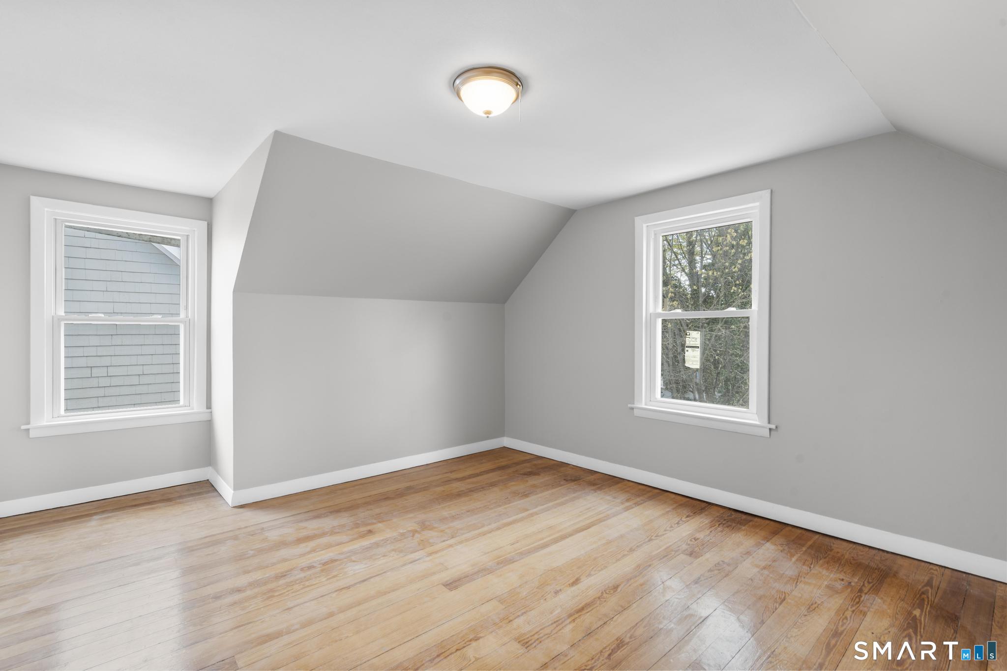 68 Whiting Street Hamden, CT 06514 - Photo 16 of 25 an empty room with wooden floor and windows