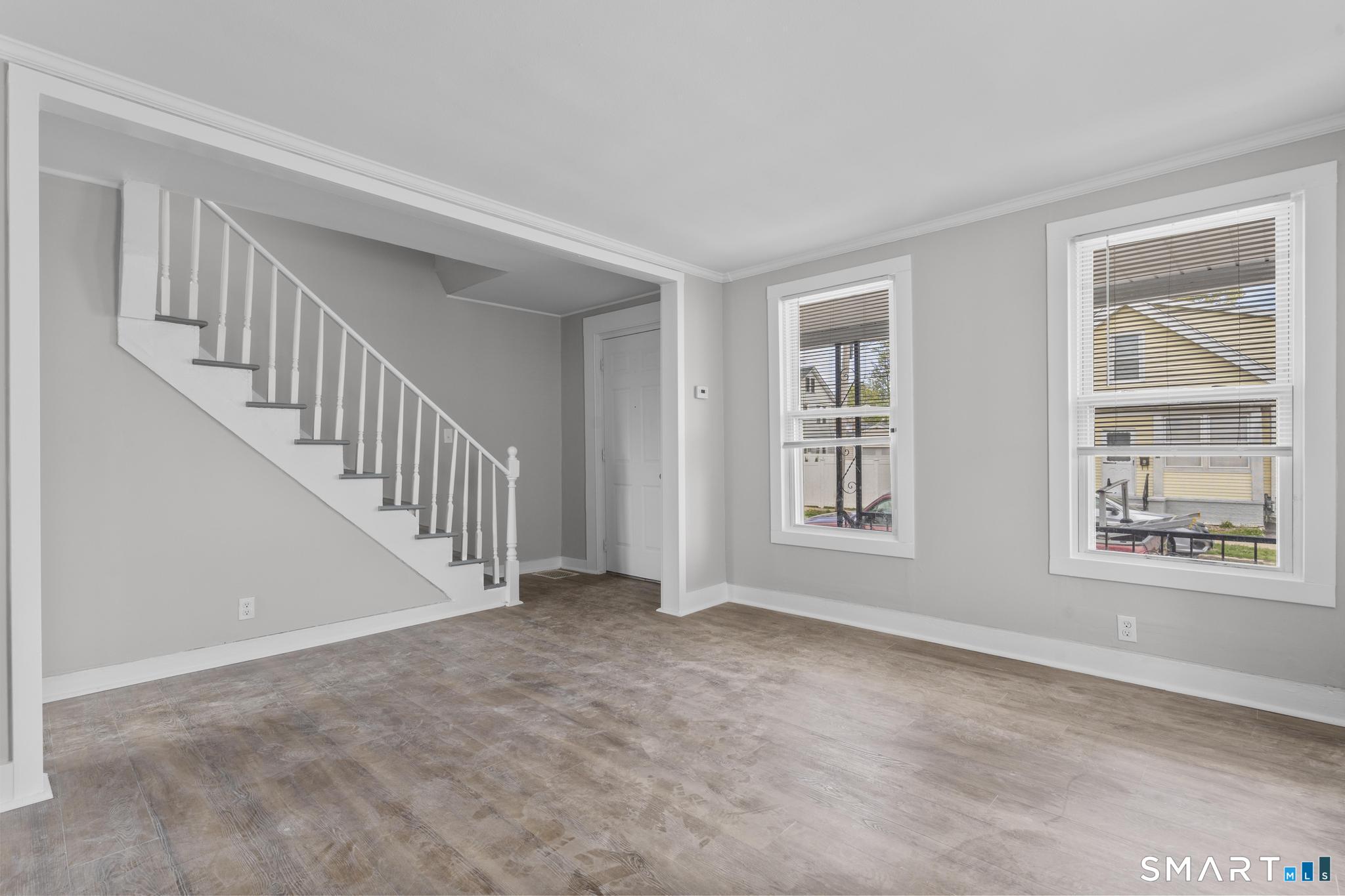 68 Whiting Street Hamden, CT 06514 - Photo 5 of 25 a view of an empty room with windows