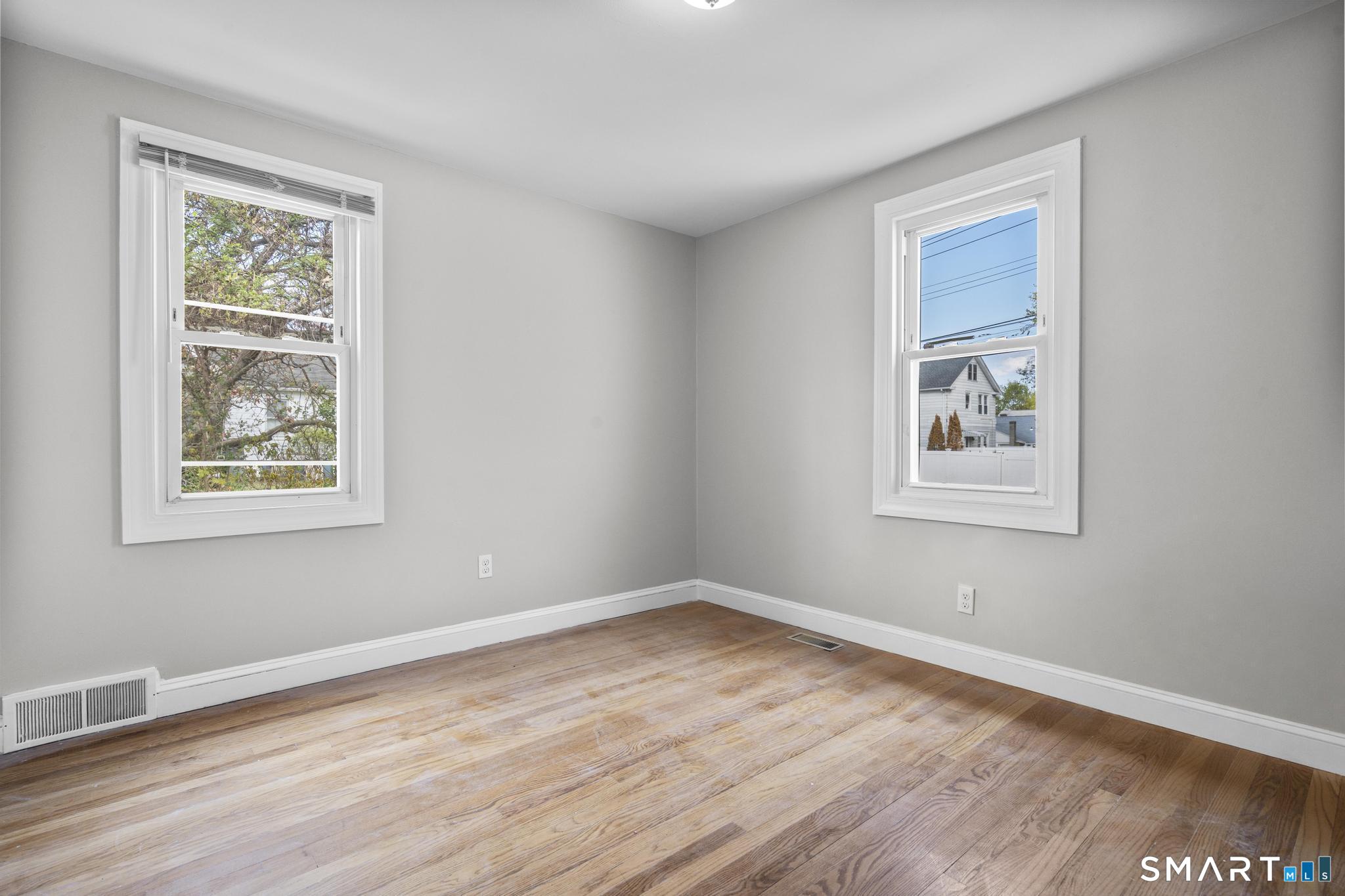 68 Whiting Street Hamden, CT 06514 - Photo 10 of 25 a view of a big room with wooden floor and windows