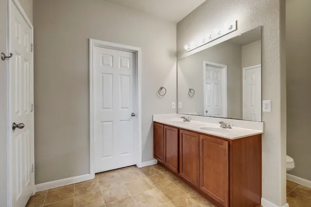 a view of a bathroom with a sink and mirror