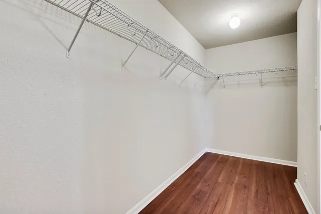 a view of a room with wooden floor