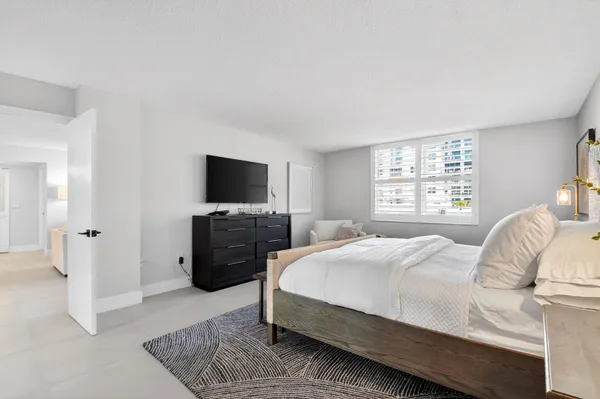 a bedroom with a bed and a television