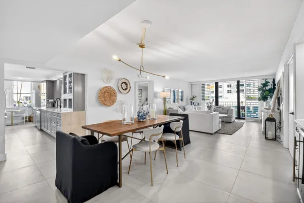 a room with lots of table chair and a view of living room