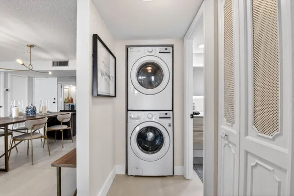 a utility room with sink dryer and washer
