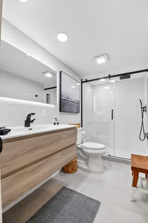 a bathroom with a toilet a sink and a shower
