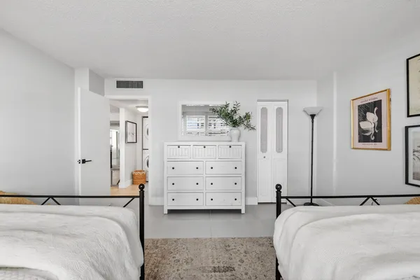 a bedroom with a bed and a dresser