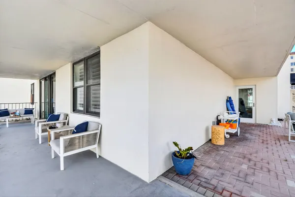 a living room with furniture and floor to ceiling window