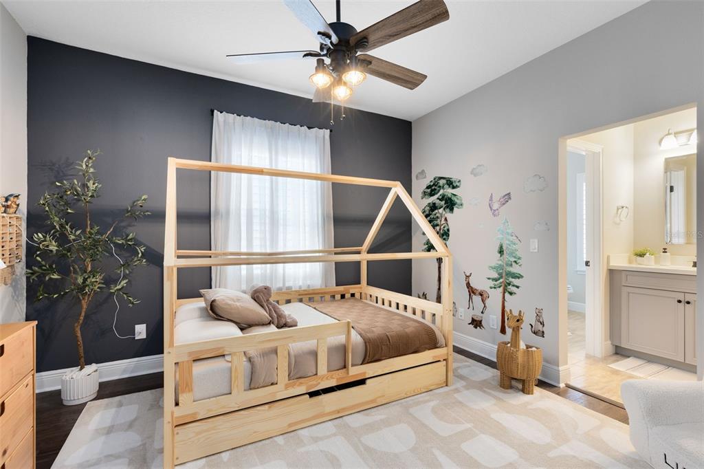 9374 Reymont Street Orlando, FL 32827 - Photo 18 of 54 a bedroom with a bed and a chandelier fan