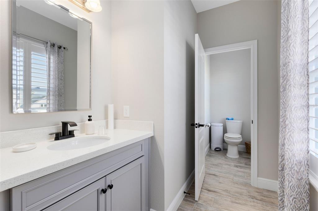 9374 Reymont Street Orlando, FL 32827 - Photo 19 of 54 a en suite bathroom with a sink a toilet and a mirror