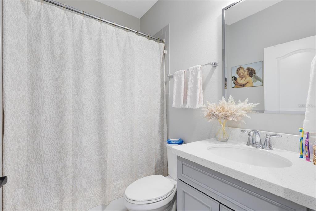 9374 Reymont Street Orlando, FL 32827 - Photo 23 of 54 a bathroom with a sink toilet and shower