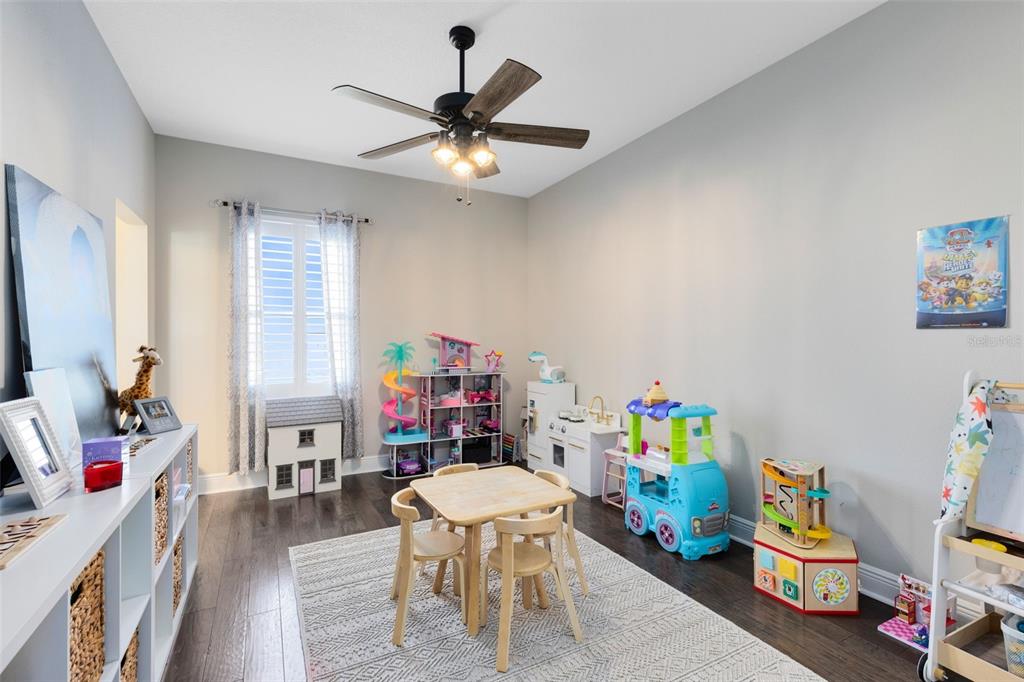 9374 Reymont Street Orlando, FL 32827 - Photo 24 of 54 a living room with furniture and a flat screen tv