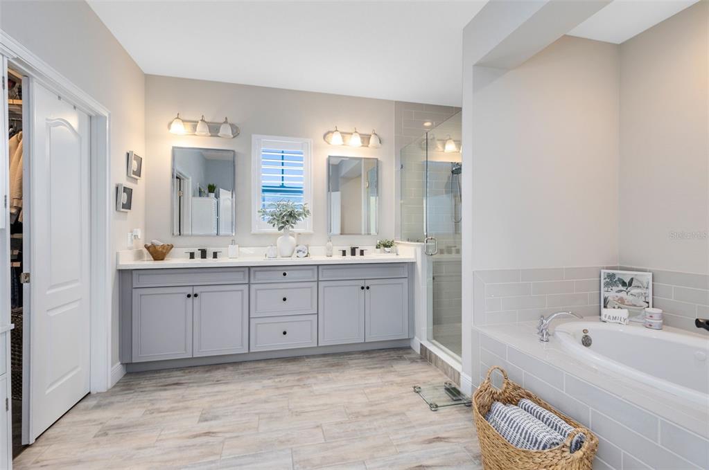 9374 Reymont Street Orlando, FL 32827 - Photo 27 of 54 a spacious bathroom with a double vanity sink mirror and double