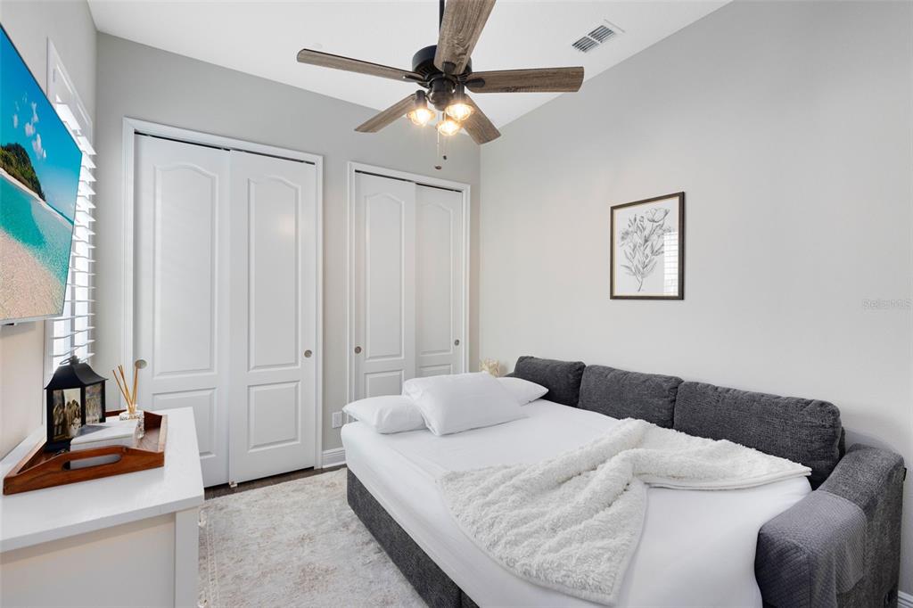 9374 Reymont Street Orlando, FL 32827 - Photo 33 of 54 a bedroom with a bed and a chandelier