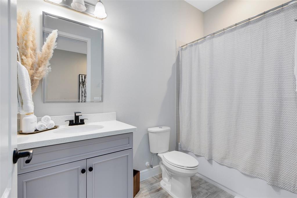 9374 Reymont Street Orlando, FL 32827 - Photo 34 of 54 a bathroom with a sink a toilet and a mirror