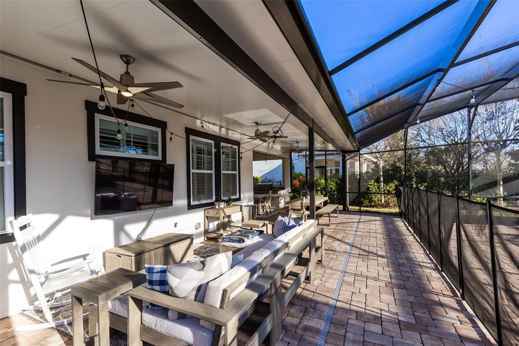9374 Reymont Street Orlando, FL 32827 - Photo 36 of 54 a view of a patio with table and chairs potted plants with floor to ceiling window
